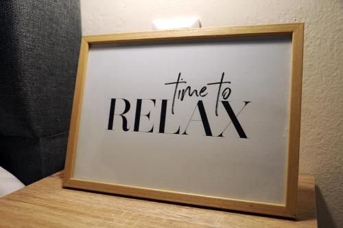 a picture frame with the words time to relax at ElMar Homeliving in Volos