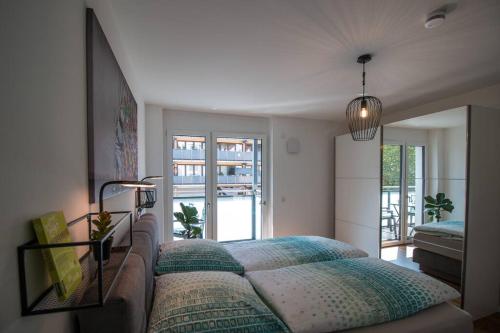 a bedroom with a bed and a large window at CityHome Christopher CHC in Kulmbach