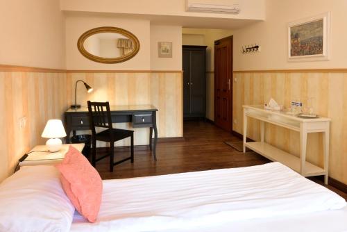a bedroom with a bed and a desk and a desk at La Fresca in Kroměříž