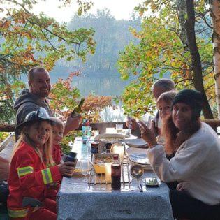 a group of people sitting around a table at The Hideaway in Želiv