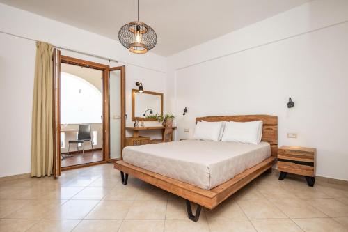 a bedroom with a bed and a desk and a window at Kallisti Studios in Naxos Chora