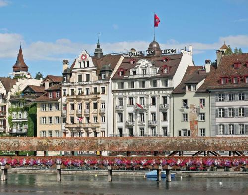 a group of buildings next to a river at Hotel Des Alpes in Lucerne