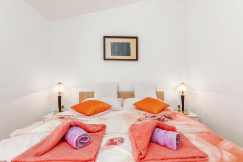 a bedroom with a large bed with two pillows on it at Denis in Vodnjan
