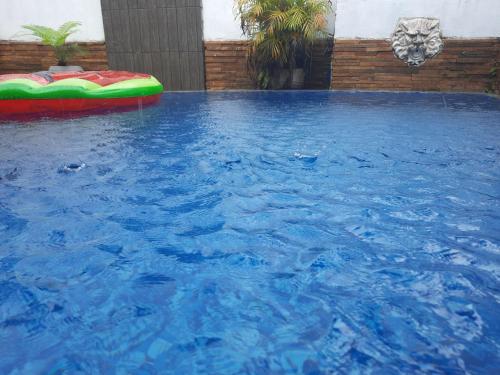 a large swimming pool with a large amount of blue water at A KAsinha do Murubira in Mosqueiro