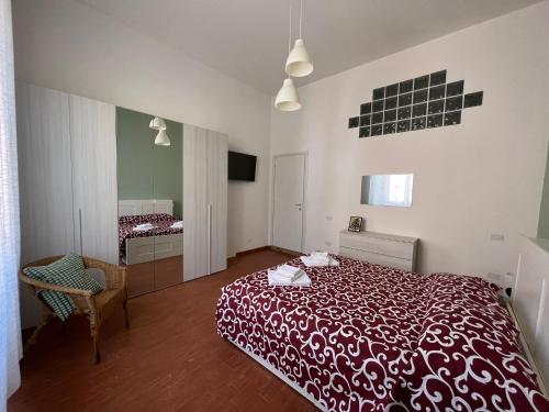 a bedroom with a red bed in a room at speZialhouse in La Spezia