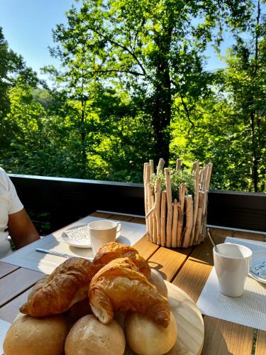 a table with croissants and pastries on top of it at Chalet 190 La Belle Durbuy in Durbuy