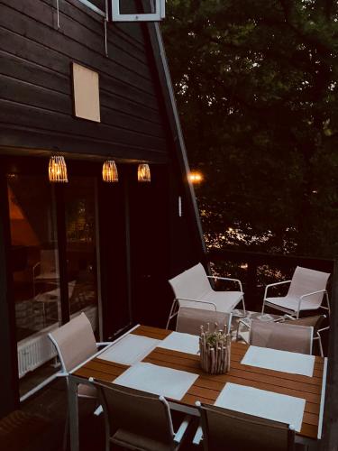 a wooden table and chairs on a patio at Chalet 190 La Belle Durbuy in Durbuy