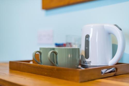 a tray with three coffee cups on a table at The Queens in Carlisle