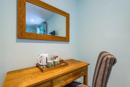 a mirror on top of a wooden table at The Queens in Carlisle