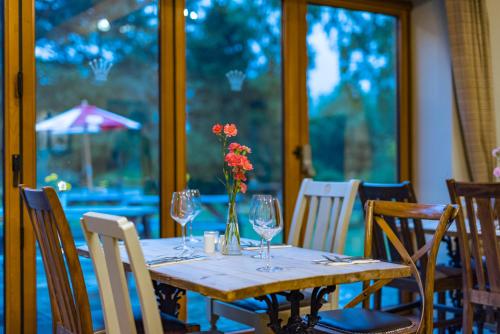 a table with a vase of flowers on it at The Queens in Carlisle