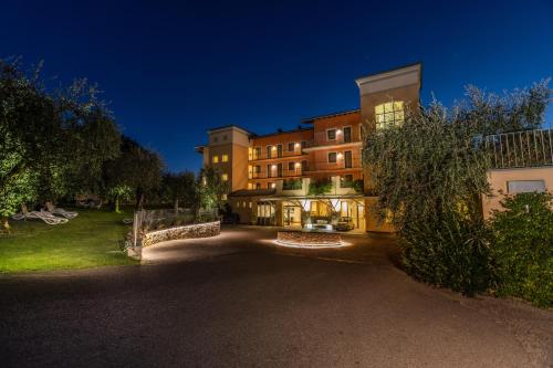 a large building at night with its lights on at Natur Resort Panorama in Malcesine