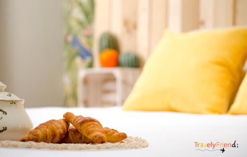 two croissants on a plate on a bed at Coqueto & Confortable Apartamento in Santiago de Compostela