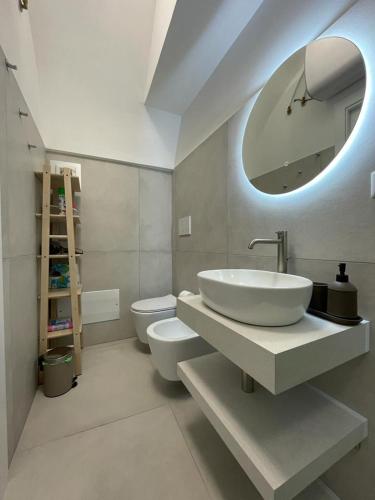 a bathroom with a sink and a toilet and a mirror at Sea Paradise in Gallipoli