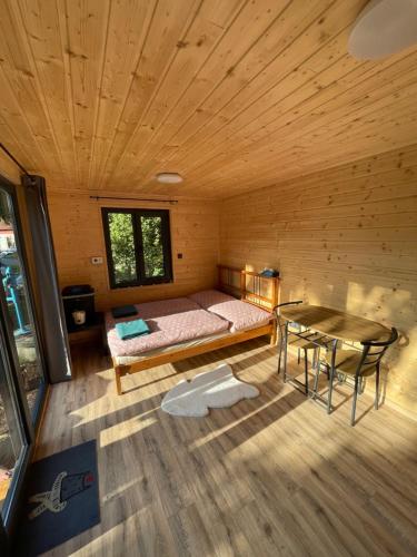 a room with a bed and a table in a cabin at Tiny House HaleLuJa 