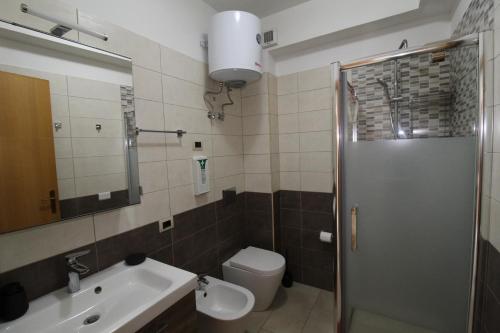 a bathroom with a toilet and a sink and a shower at Casa vacanze Leto in Letojanni