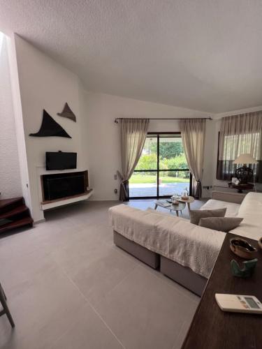 a large bedroom with a large bed and a table at Sani Forest Luxury Villa in Sani Beach