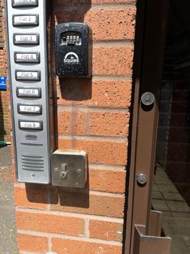 a cell phone is attached to a brick wall at The Bank in Lewes