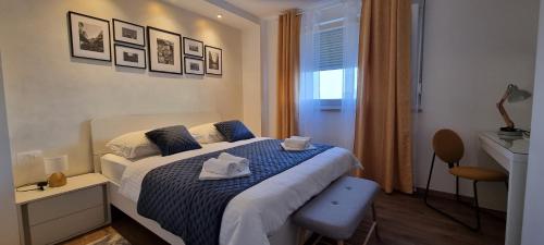 a bedroom with a bed with two towels on it at QR Apartment for Family, Couples, and Friends stay in Rijeka in Rijeka