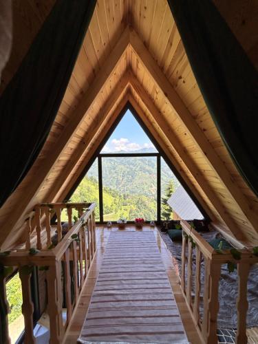 a wooden bridge in a roof with a window at Takidagevleri in Çamlıhemşin