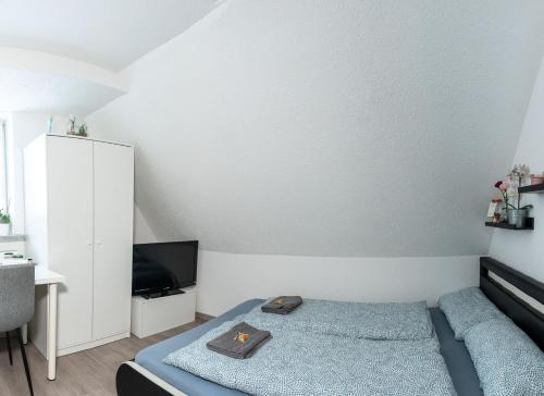 a small bedroom with a bed and a tv at modern house with pool - 3 bedrooms 2 Bathrooms in Memmingen