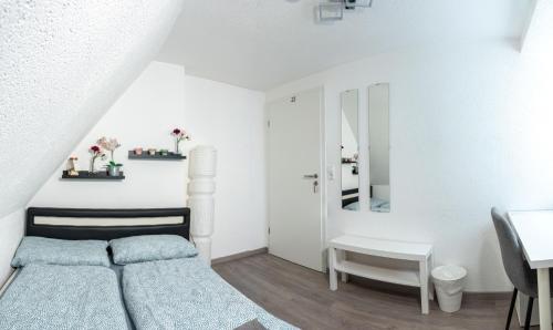 a bedroom with a bed and a desk and a mirror at modern house with pool - 3 bedrooms 2 Bathrooms in Memmingen