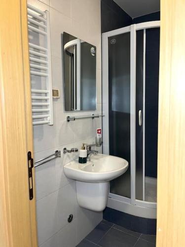 a bathroom with a sink and a toilet and a mirror at Studio Pao in Podgorica