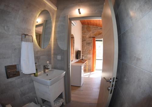 a bathroom with a sink and a mirror at Begonvillage Tatil Evleri in Datca