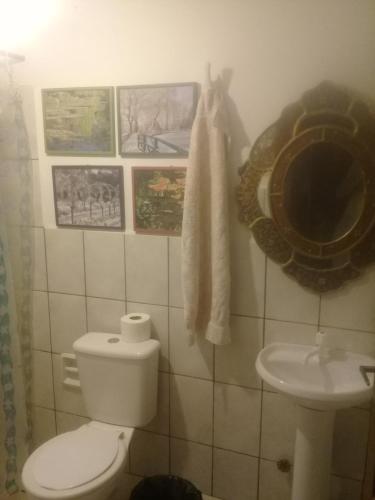 a bathroom with a toilet and a sink at Los Aventureros in Samaipata