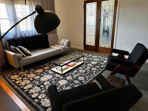 a living room with a couch and a table at Tranquilo Daylesford in Daylesford