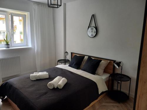 a bedroom with a bed with two towels on it at katedrahouse in Wrocław