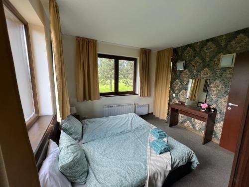 a bedroom with a bed and a window at The Nature View Suite, part of Terra Complex & Spa in Bansko