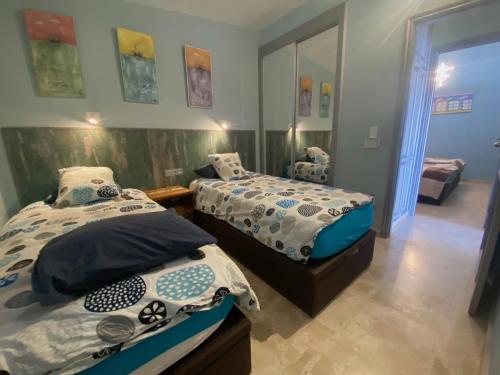 a bedroom with two beds in a room at Virgen del Carmen in Abades