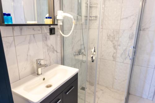 La salle de bains est pourvue d'un lavabo et d'une douche. dans l'établissement Pera Side Hotel, à Sidé
