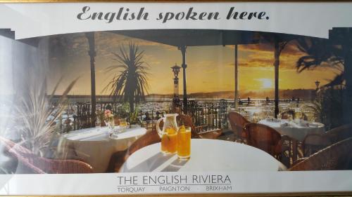 a window of a restaurant with tables with glasses of orange juice at The Rosslyn in Paignton