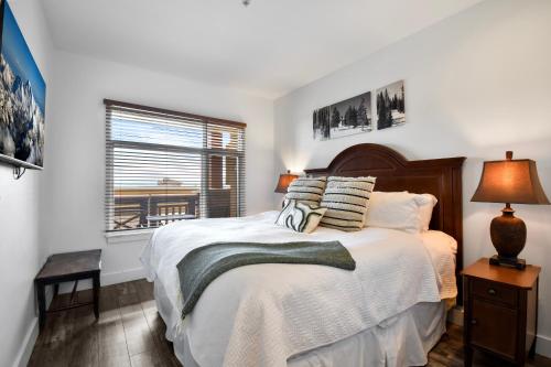 a bedroom with a bed with white sheets and a window at Sundial Lodge Superior 1 Bedroom by Canyons Village Rentals in Park City