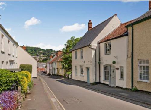 an empty street in a small town with houses at Carpenters Cottage Quirky home Seaside town in Minehead