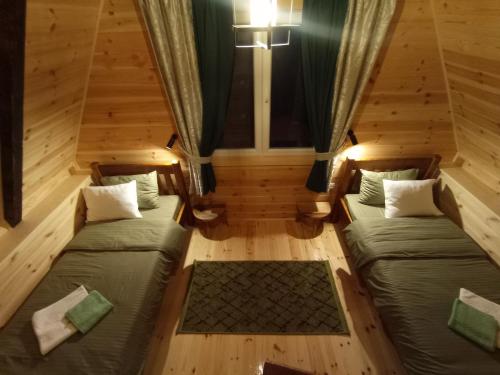an overhead view of two beds in a room at Cottage Usovic in Žabljak