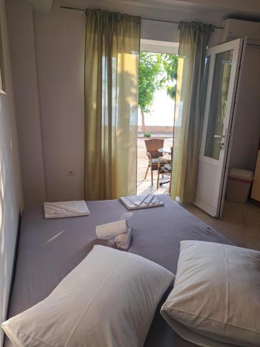 a bedroom with two beds and a door to a patio at Apartmani ante 3 in Drašnice
