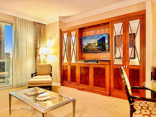 a living room with a couch and a table and a tv at Amalz Suites Collection at MGM Signature ! in Las Vegas
