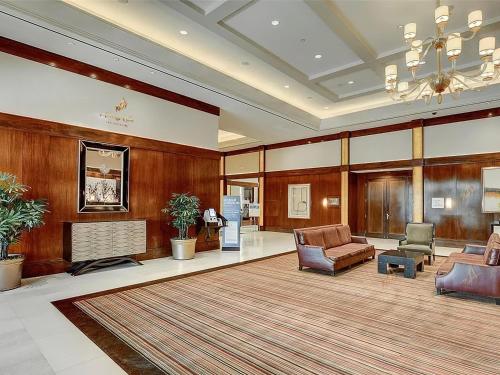 a lobby with chairs and a couch and a fireplace at Amalz Suites Collection at MGM Signature ! in Las Vegas