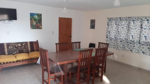 a dining room with a table and chairs and a couch at Lujan de Cuyo Mendoza in Ciudad Lujan de Cuyo