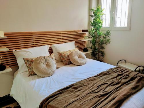 a bedroom with a large bed with pillows on it at BS apartamentos Aledo14 in Novelda