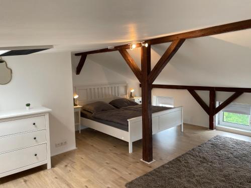 a bedroom with a bed with wooden beams at Ferienwohnung Hansezauber Lübeck in Lübeck