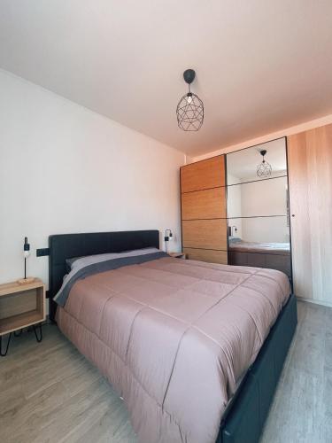 - une chambre avec un grand lit et un miroir dans l'établissement Casa Mirella, à Sanremo