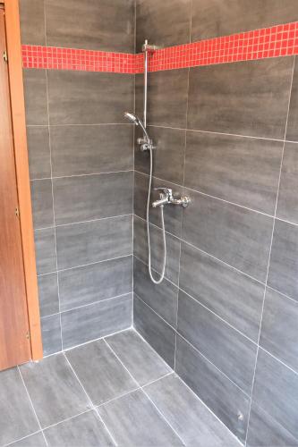 a bathroom with a shower with gray tiles at B&B Ospedale Pescara in Pescara