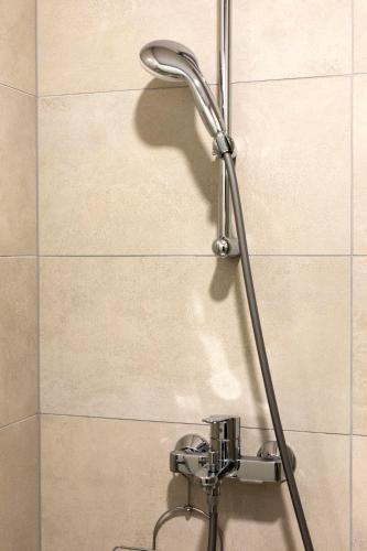 a shower head on a wall in a bathroom at Apartman Elena Ekolu in Split