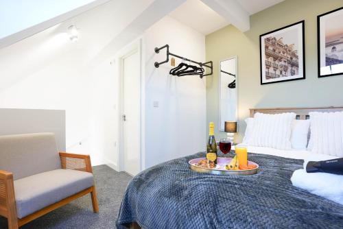 a bedroom with a bed and a table with a bottle of wine at Central Buckingham Apartment #5 with Free Parking, Pool Table, Fast Wifi and Smart TV with Netflix by Yoko Property in Buckingham