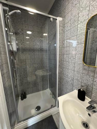 a bathroom with a shower and a sink at DVMescape flat1 in Bristol