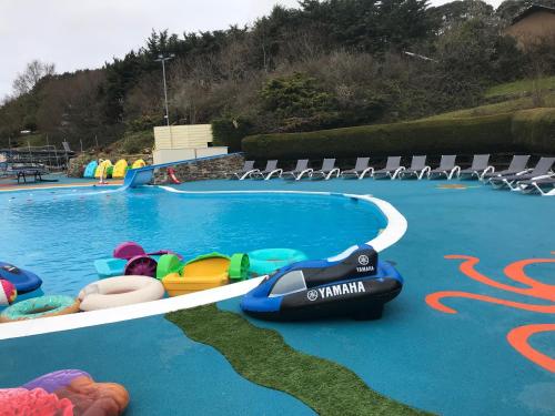 a swimming pool with inflatables on the side of it at Exclusive 3 Bedroom Caravan, Sleeps 8 People at Parkdean Newquay Holiday Park, Cornwall, UK in Porth