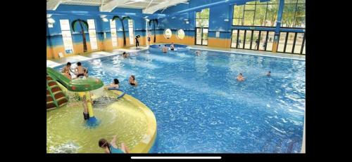 a group of people in a large swimming pool at Billing Aquadrome Luxury 2022 Static Caravan Sleeps 6 in Great Billing